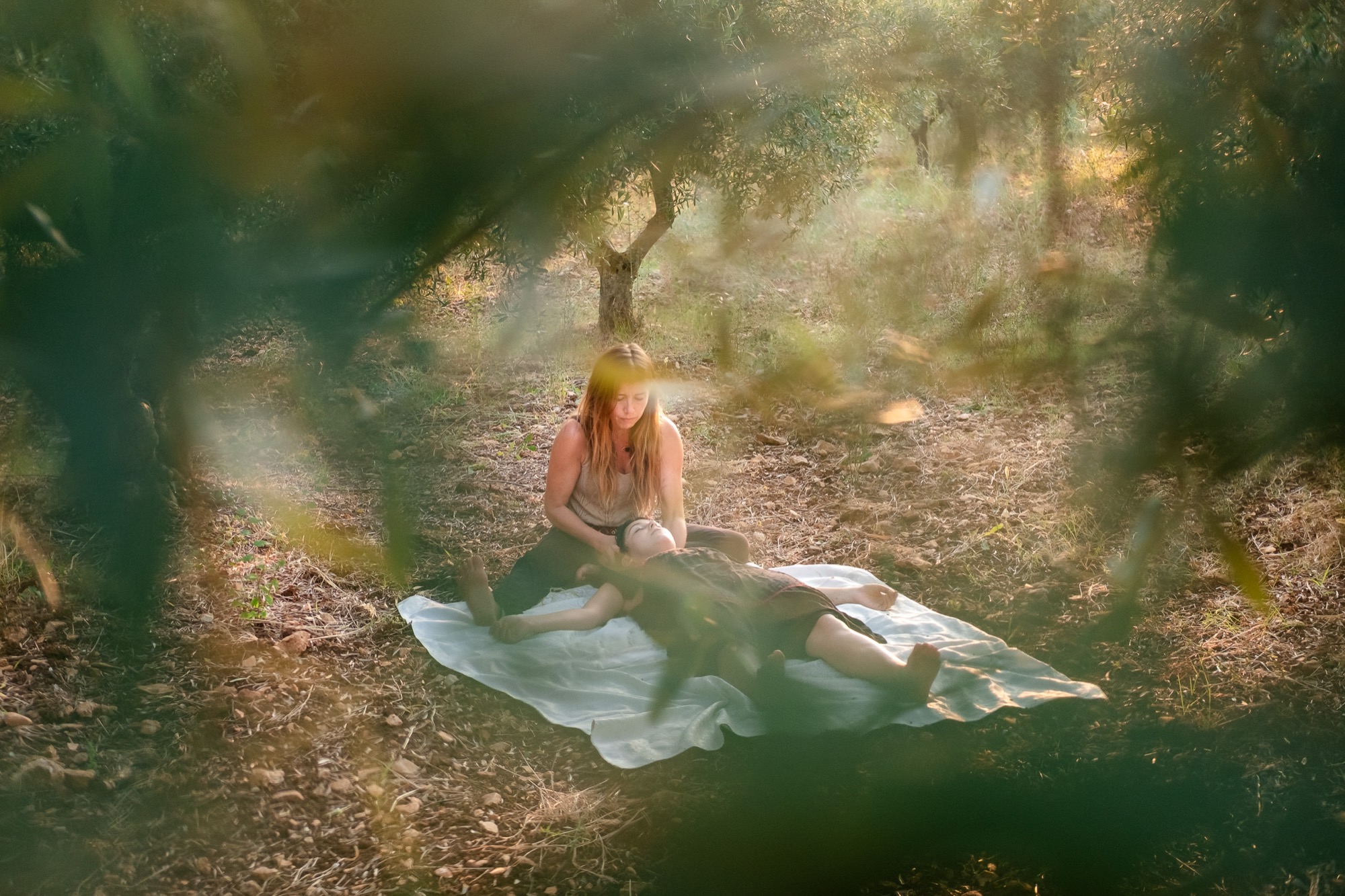 Kathrin offering a bodywork session beneath olive trees