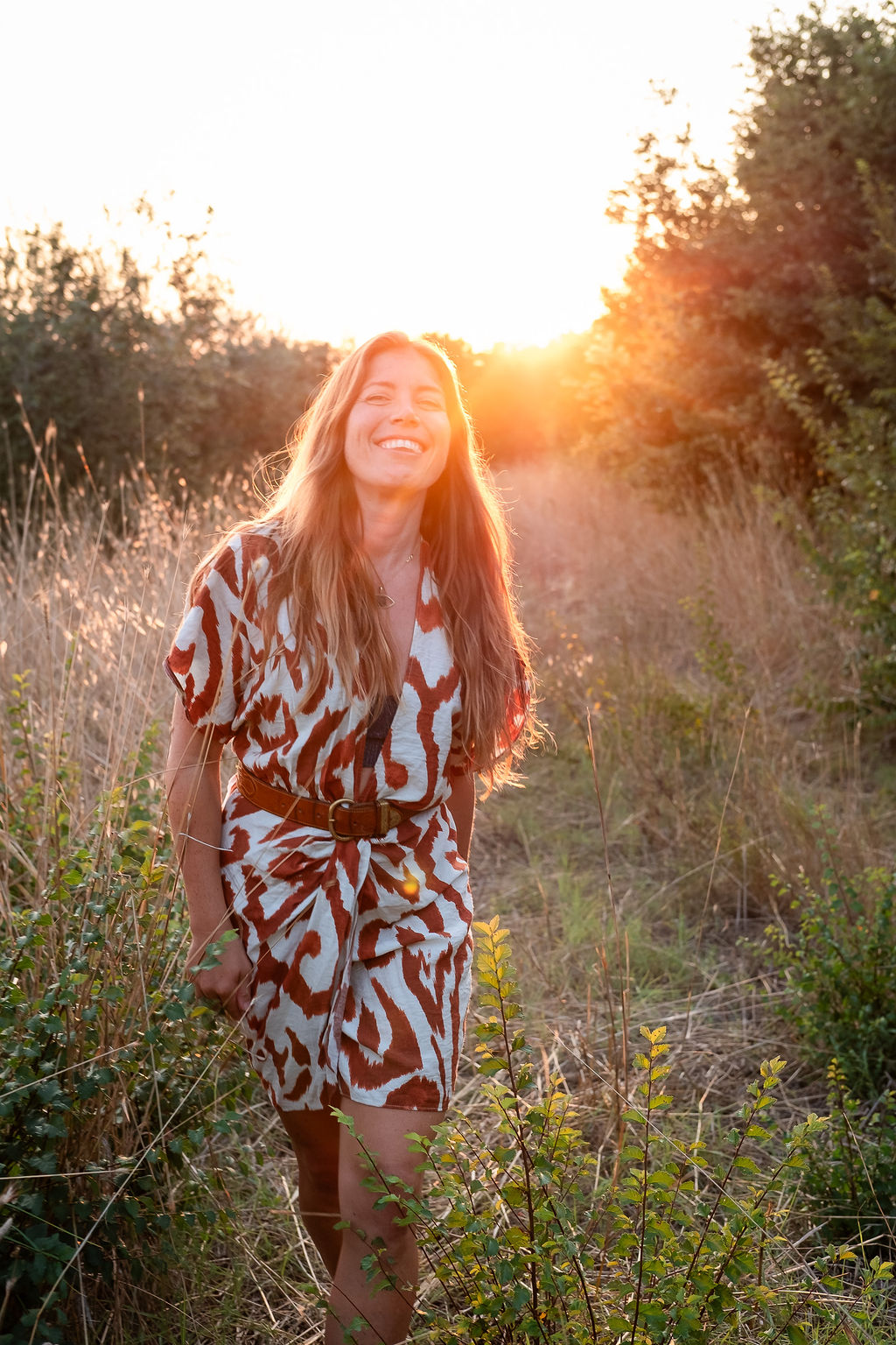 Kathrin smiling outdoors in warm evening sunlight