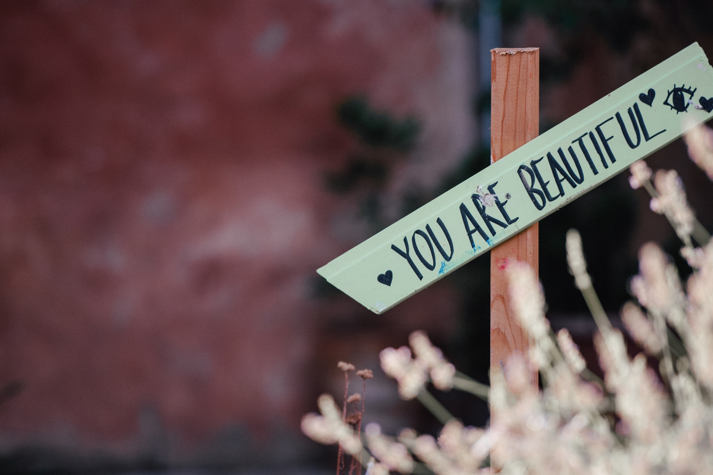 A hand-painted sign reading You Are Beautiful